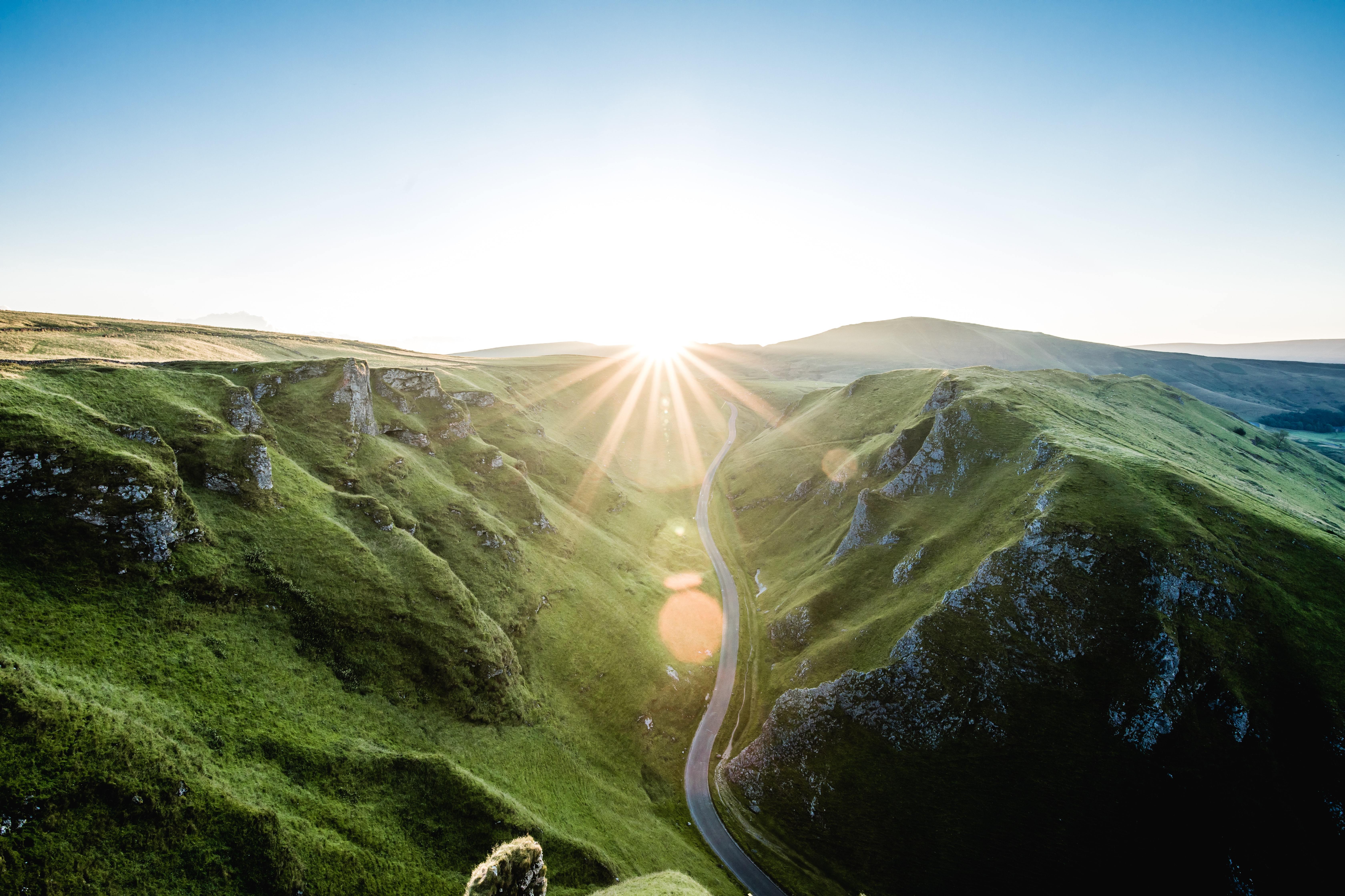 Road between two mountains and a sunrise