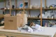 cardboard box and brown paper bag on wooden table